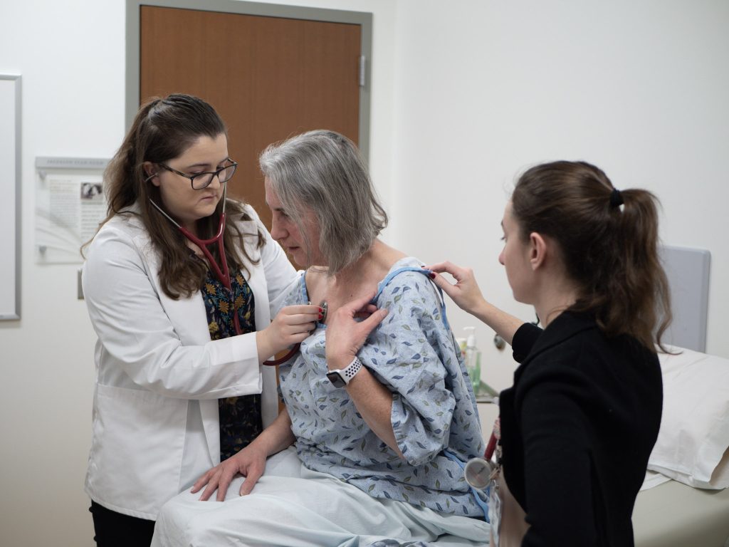 Students working in mock clinical setting.